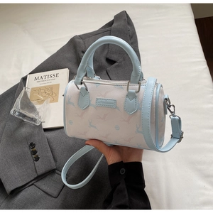 Close-up of stylish light blue Boston bag with deer print and Nicani brand label
