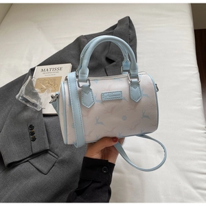 Detail of light blue Boston bag with deer print, dual handles, and adjustable strap