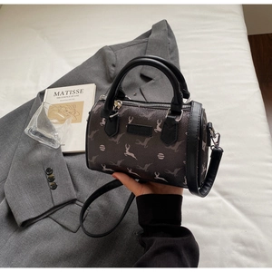 Detail of Boston bag featuring white deer print on dark brown fabric with dual handles