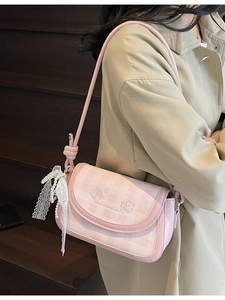 Pink plaid crossbody bag with heart embroidery and pearl lace bow charm shown on model