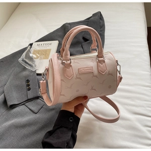 Close-up of pink Boston bag with deer print, twin handles and silver hardware