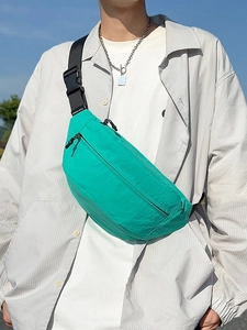 Neon green large nylon waist bag for men and women with adjustable strap in outdoor setting