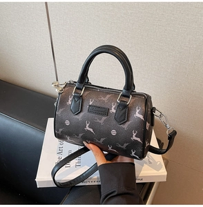 Detail of dark brown leather Boston bag with deer print and premium leather handles
