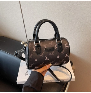 Detail of deer pattern on dark brown textured faux leather mini boston bag with handles