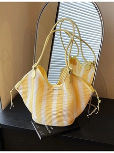 Large woven mesh tote bag in yellow and white stripes with leather shoulder straps