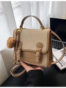 Beige and khaki minimalist backpack for women with decorative straps and bear charm
