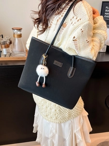 Black large capacity tote bag with long-legged monster pendant for daily commute