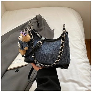 Λεπτομέρεια τσάντας denim με λουστρίνι, ασημένια αλυσίδα και κρεμαστό αρκουδάκι