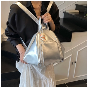 Silver metallic PU backpack featuring geometric structure and cute cat charm detail