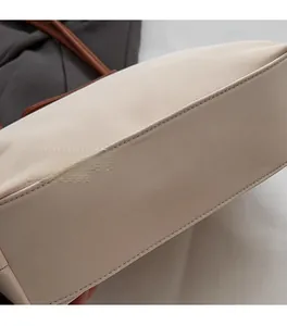 Close-up of dual-line stitching on high-density beige fabric of a tote bag