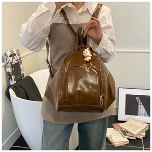 Glossy brown lacquer leather backpack with cute white rabbit plush charm for women