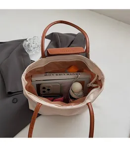 Spacious interior of beige tote bag showing large capacity for books and accessories