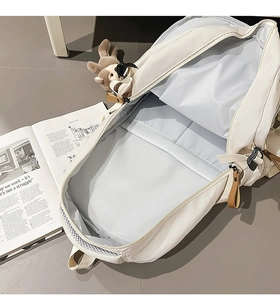 Detail view of spacious blue interior with organizers and leather zipper pull on canvas bag