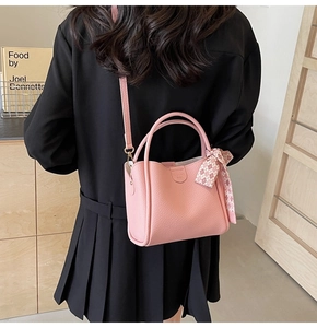 Pink lychee grain leather bucket bag with plaid scarf decoration on model back view