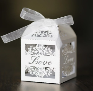 White laser-cut Love candy box with elegant organza ribbon for wedding favors