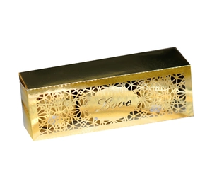 Macro shot of gold hollow-out wedding candy box featuring elegant Love laser-cut design