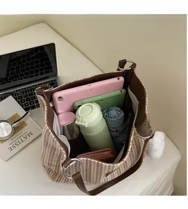 Interior view showing the large capacity of the striped canvas tote bag with leather trim
