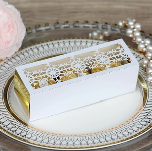 White laser-cut snowflake gift box with gold interior and luxury party favors
