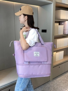 Large purple travel duffel bag with water-resistant nylon and expandable bottom layer
