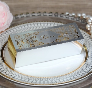 Detailed laser-cut hollow pattern and LOVE engraving on golden wedding candy favor box
