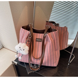 Close-up of pink and brown arrow texture fabric tote bag with premium leather straps