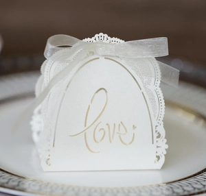 Detailed laser cut white candy box with Love lettering and delicate lace edges