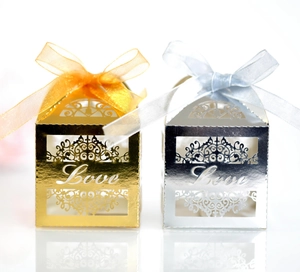 Detailed view of hollowed 'Love' candy box in gold and silver with elegant ribbons