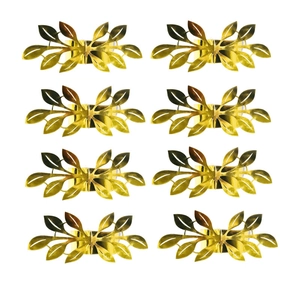 Close-up of 8-piece set of shiny golden metal leaf napkin rings on white background