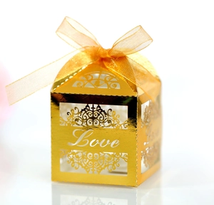 Detailed laser-cut LOVE wedding candy box in gold finish with a satin ribbon bow