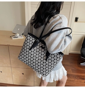 Detail shot of a large tote bag with black and white floral pattern for daily commute