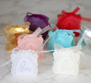Detailed laser-cut wedding gift boxes with Love inscription and silk ribbons in various colors