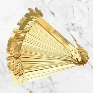 Detailed macro view of golden leaf napkin ring with intricate texture on marble