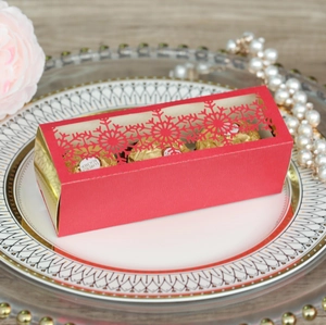 Detail of red hollow snowflake candy box with gold accents for Christmas gift packaging