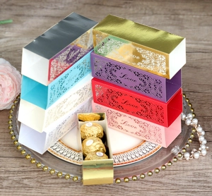 Close-up of hollow LOVE candy boxes in various colors stacked on a wooden table