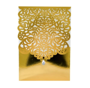 Detailed laser-cut floral pattern on gold wedding invitation card with drop diamond