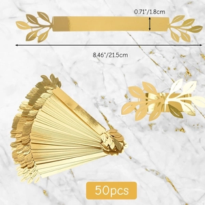 Detail of 50pcs gold leaf napkin rings with laser-cut veins on marble background