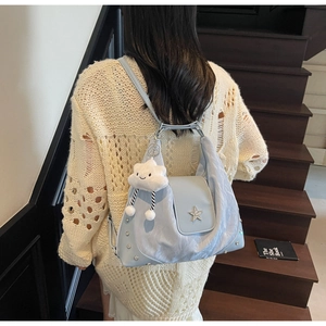 Light blue canvas tote bag featuring a star buckle and a plush cloud charm accessory