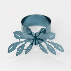 Detailed close-up of metallic blue-grey leaf butterfly napkin ring on a white surface