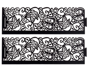Detail view of two black laser-cut decorative panels with leaf and heart patterns