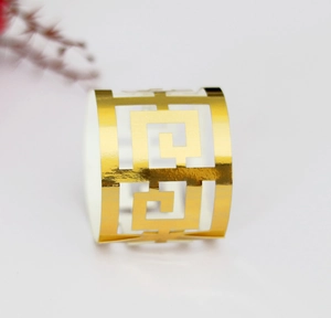 Vue macro d'un rond de serviette doré avec un motif géométrique creux sophistiqué