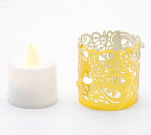 Close-up of golden hollowed-out leaf pattern metal lampshade and LED candle light
