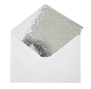 Close-up of laser-cut rose floral texture on a shimmering silver wedding invitation card