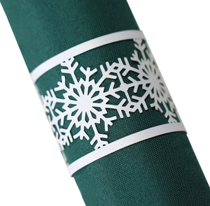 White laser-cut snowflake napkin ring with a minimalist festive design for table settings