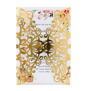 Detail of laser-cut rose gold wedding invitation with floral inner card and hollow pattern
