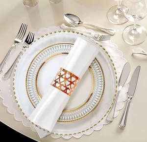 Elegant rose gold hollow heart napkin ring shown on a white fabric napkin for table setting