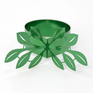 Detail of green leaf napkin ring with butterfly cutout design and glossy metal finish