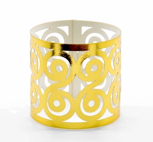 Close-up of golden laser-cut napkin ring with elegant spiral pattern for weddings