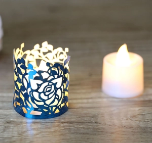 Blue hollow rose pattern paper lampshade with LED candle light on wooden table
