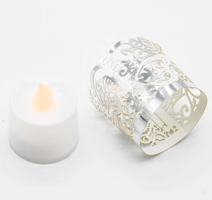 Detailed view of silver laser-cut heart pattern sleeve with LED electronic candle light