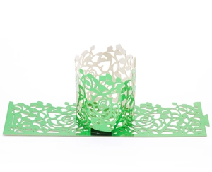 Detail of emerald green laser-cut cupcake wrappers with rose flower patterns and lock